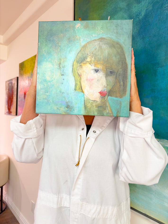 Person holding Self Portrait by Victoria Evans in front of their face